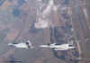 A MiG in formation with a GRIPEN over Laage AB.